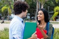 Indian female student talking with caucasian male student Royalty Free Stock Photo