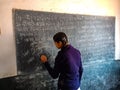 an indian female student writing on chalkboard in india January 2020 Royalty Free Stock Photo