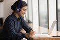 Indian female wear headphones listen audio course learn english language Royalty Free Stock Photo