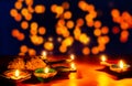 Indian festival Diwali, Diya oil lamps lit on colorful rangoli. Hindu traditional. Happy Deepavali. Copy space for text Royalty Free Stock Photo
