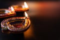 Indian festival Diwali, Diya oil lamps lit on colorful rangoli. Hindu traditional. Happy Deepavali. Copy space for text