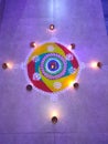 Indian festival diwali rangoli, beautiful and colorful, decorated with diyas and radiating blue light in background, happy celebra