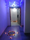 Indian festival diwali rangoli, beautiful and colorful, decorated with diyas and radiating blue light in background, happy celebra