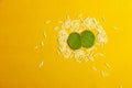 Indian Festival Dussehra , green leaf and rice on yellow background