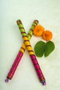 Indian Festival Dussehra, showing golden leaf Bauhinia racemosa and marigold flowers with Dandiya sticks