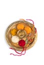 Indian Festival Raksha Bandhan with Rakhi and rice grains, kumkum, sweets and Diya on a worship plate Royalty Free Stock Photo