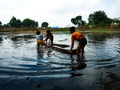 indian fisher kids pulling boat at river village in India January 1, 2020