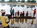 indian fisherman holded laptop computer system at river bank in india January 2020