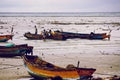 Indian fishermen on the beach with their boats