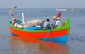 Indian fishermen catching fish for food in wooden boats