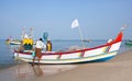 Indian fishermen catching fish for food in wooden boats in Arabian sea, Kerala, South India