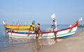 Indian fishermen catching fish for food in wooden boats