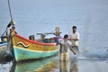 Indian fishermen preparing fishing nets for upcoming voyage