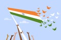 Butterflies emerging out from the Indian tricolour flag hoisted by hands of people