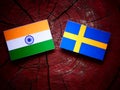 Indian flag with Swedish flag on a tree stump Royalty Free Stock Photo