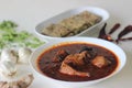 Indian flat bread made of whole wheat flour with grounded flax seed and fresh coriander leaves served with red gravy fish curry Royalty Free Stock Photo