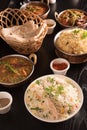 Indian food ;curries, chapathi, fried rice and biriyani on a black marble background. Royalty Free Stock Photo