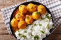 Indian food: Dum aloo potatoes in a sauce with rice close-up. ho