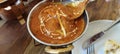 Indian food including curries, spice sauce and naan bread.