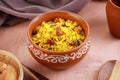 Indian Food Maharashtra Poha with Peanuts in a Pottery Bowl