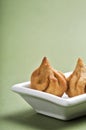 Indian Food: Modak on green background, Maharashtra Sweet Dish, favourite sweet of lord ganesha, greeting card design. Copy-space