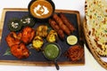 indian food speciality tandoori mix platter, includes chicken tikka, lamb seekh kebab, fish tikka, hara bhara kabab, dal makhani Royalty Free Stock Photo