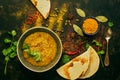 INDIAN FOOD. Thick Indian red lentil soup in the background with spices and homemade bread pita, lavash bread . View from above Royalty Free Stock Photo