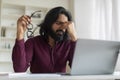 Indian Freelancer Guy Feeling Unwell While Working On Laptop At Home Office Royalty Free Stock Photo