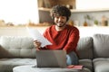 Indian Freelancer Man In Headset Working With Papers And Laptop At Home Royalty Free Stock Photo