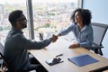 Indian ceo and African American newcomer shaking hands in modern office. Royalty Free Stock Photo