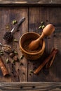 Indian Garam masala powder with ingridients on wooden background