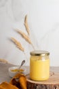 Indian ghee clarified butter desi in glass jar on wood slice. Royalty Free Stock Photo