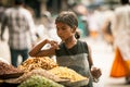 Indian girl bying sweets from the street