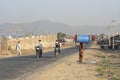 Indian girl carries on her head a big barrel along the road near the city Pushkar , Rajasthan, India Royalty Free Stock Photo