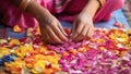 Indian girl making marigold flower garland