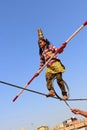 Indian girl performs street acrobatics by walking the rope