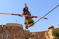 Indian girl performs street acrobatics by walking the rope