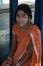 Indian girl sitting waiting the train.