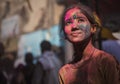 An Indian girl smeared with colours on her face poses for a photograph during the Holi festival celebration in Mathura, India Royalty Free Stock Photo