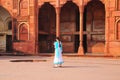 Indian girl standing in the courtyard of Jahangiri Mahal in Agra