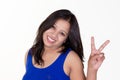 indian girl wearing a blue sleevless t shirt showing victory sign