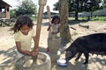 Indian girls are pounding rice with rice pestles