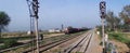 Indian Goods train with trees on both sides of track