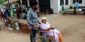 An indian grandson taking his grandmother around hospital area for checkups Royalty Free Stock Photo