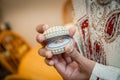 Indian groom holding ring