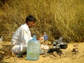 Indian guide cooking for tourists during camel safari in Thar de