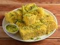 Indian Gujarati Khaman Dhokla made using Dal, served with Green chutney, selective focus Royalty Free Stock Photo
