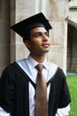 Indian guy in a graduation gown.