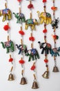 Handmade wind chimes with bells and small decorated toy elephant Royalty Free Stock Photo