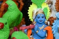 Indian handicraft statue of god Lord Krishna, many handmade colorful sculptures of Hindu god